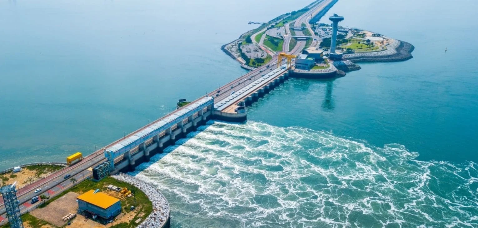 Tidal barrage and wave energy converters capturing ocean power